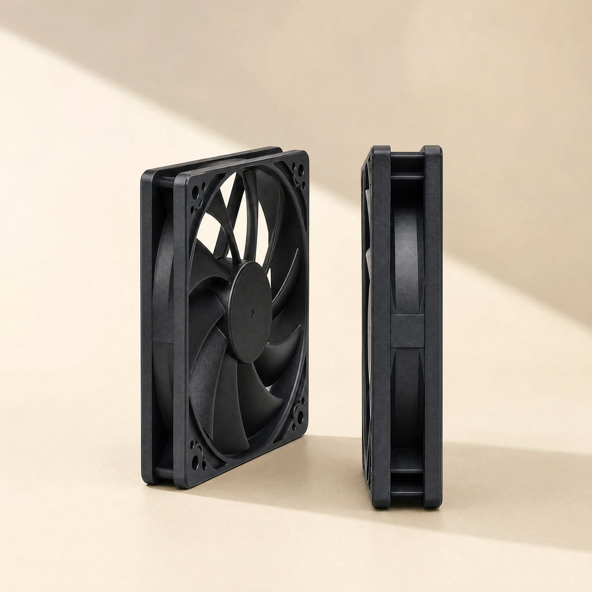 Airframe – Two black slim fans standing on a cream surface, one angled to show blades, the other edge-on for thickness