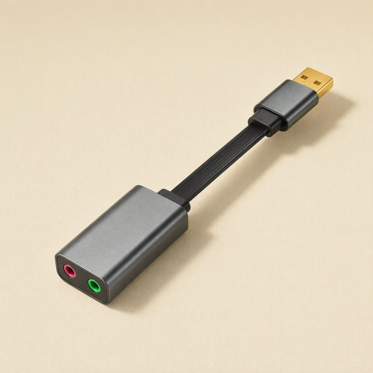 Twintone – Gray adapter on a short flat black cable, shown at an angle with pink and green jacks facing forward