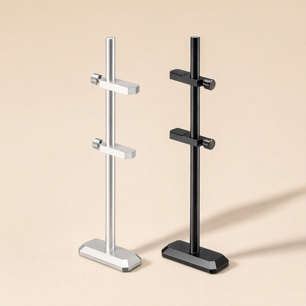 Chipbrace aluminum alloy graphics card bracket in silver and black, each with two clamp arms, on beige
