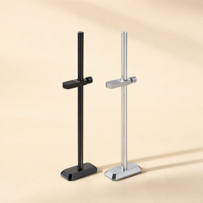 Chipbrace – Black and silver graphics card brackets with angled bases, one clamp arm each, on a warm beige surface