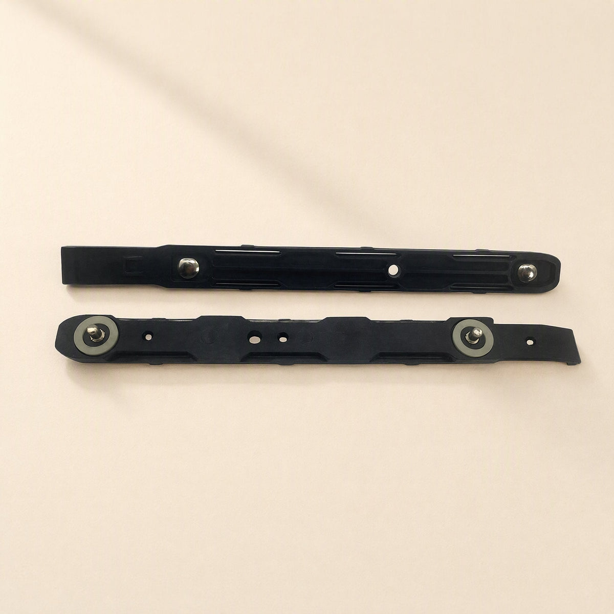 Coolbrace Hard Drive Bracket – two black bracket rails with metal pins and grey washers, shown alone on a cream background