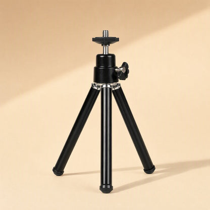Phoneprop Aluminum Alloy Desktop Phone Stand, black tripod with legs retracted on a beige background