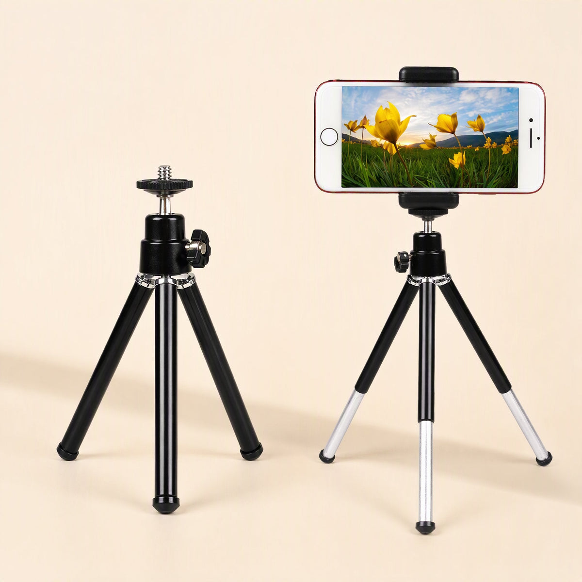 Phoneprop – Two tripods side by side, one black and compact, the other extended with a smartphone mounted in landscape