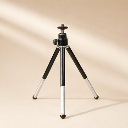 Phoneprop – Black ball-head tripod with extended silver legs and bare mounting screw, in soft diagonal light