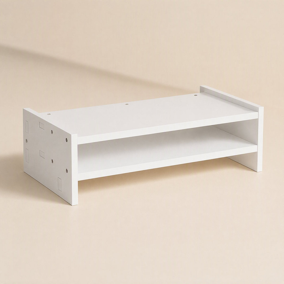 Screenstore – Plain white two-tier monitor stand shown from the left side, with screw holes visible on the end panel
