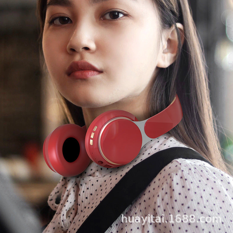 Headtone – Woman with long hair wearing red over-ear headphones around her neck, dotted blouse and black strap