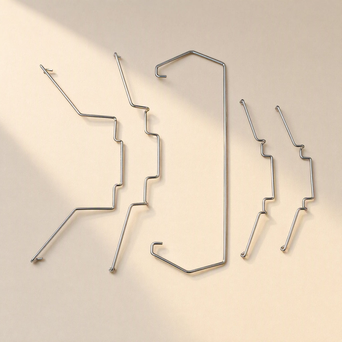 Fanclasp Steel Wire CPU Fan Buckle set of five silver wire clips laid out on a cream background