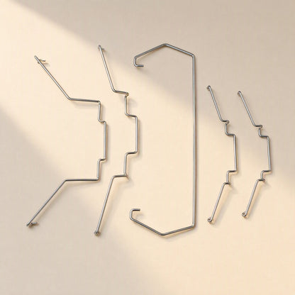 Fanclasp Steel Wire CPU Fan Buckle set of five silver wire clips laid out on a cream background