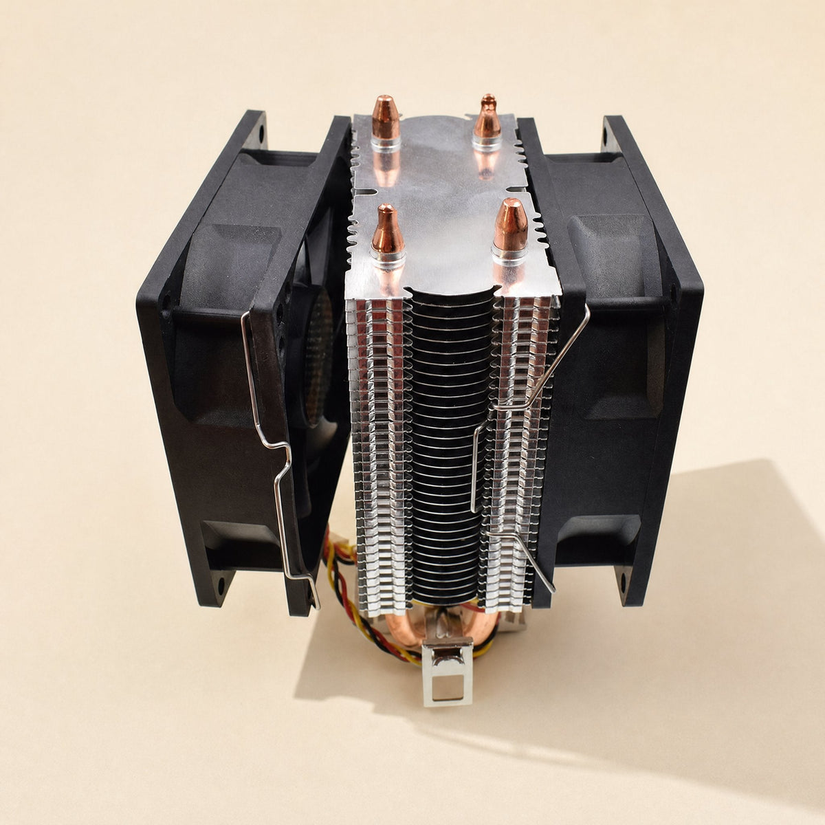 Fanclasp – Silver wire clips holding two black fans on either side of a CPU heatsink with copper heat pipes, top view