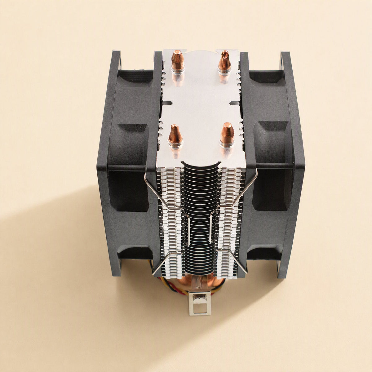 Fanclasp – Top-down view of wire fan clips securing black fans to an aluminum fin heatsink with copper tips