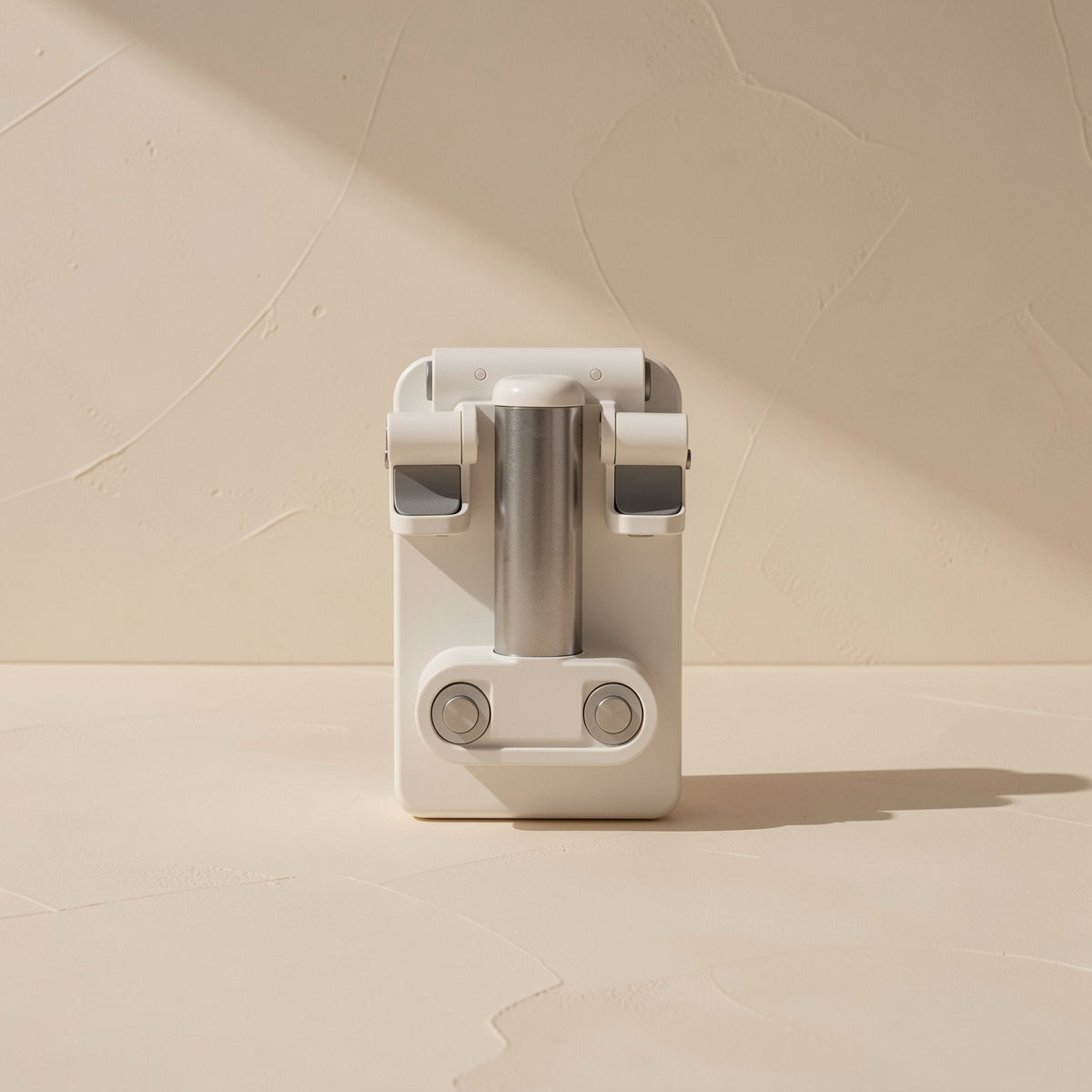 Deskease – Front view of the folded holder showing the metal column, hinge and two round pivot buttons