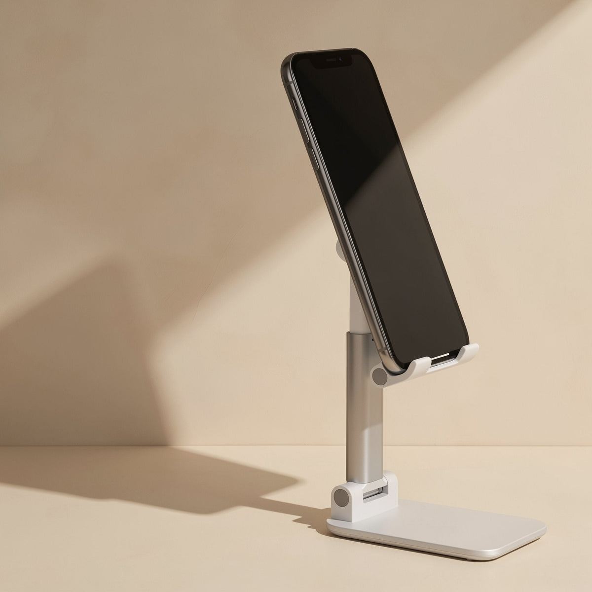 Deskease Alloy Desktop Phone Holder – side view of the white holder with a phone propped at an angle on the extended arm