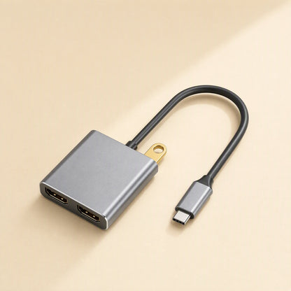Twinview – Gray dual HDMI docking station with short cable, USB-C plug and gold USB connector on a cream background