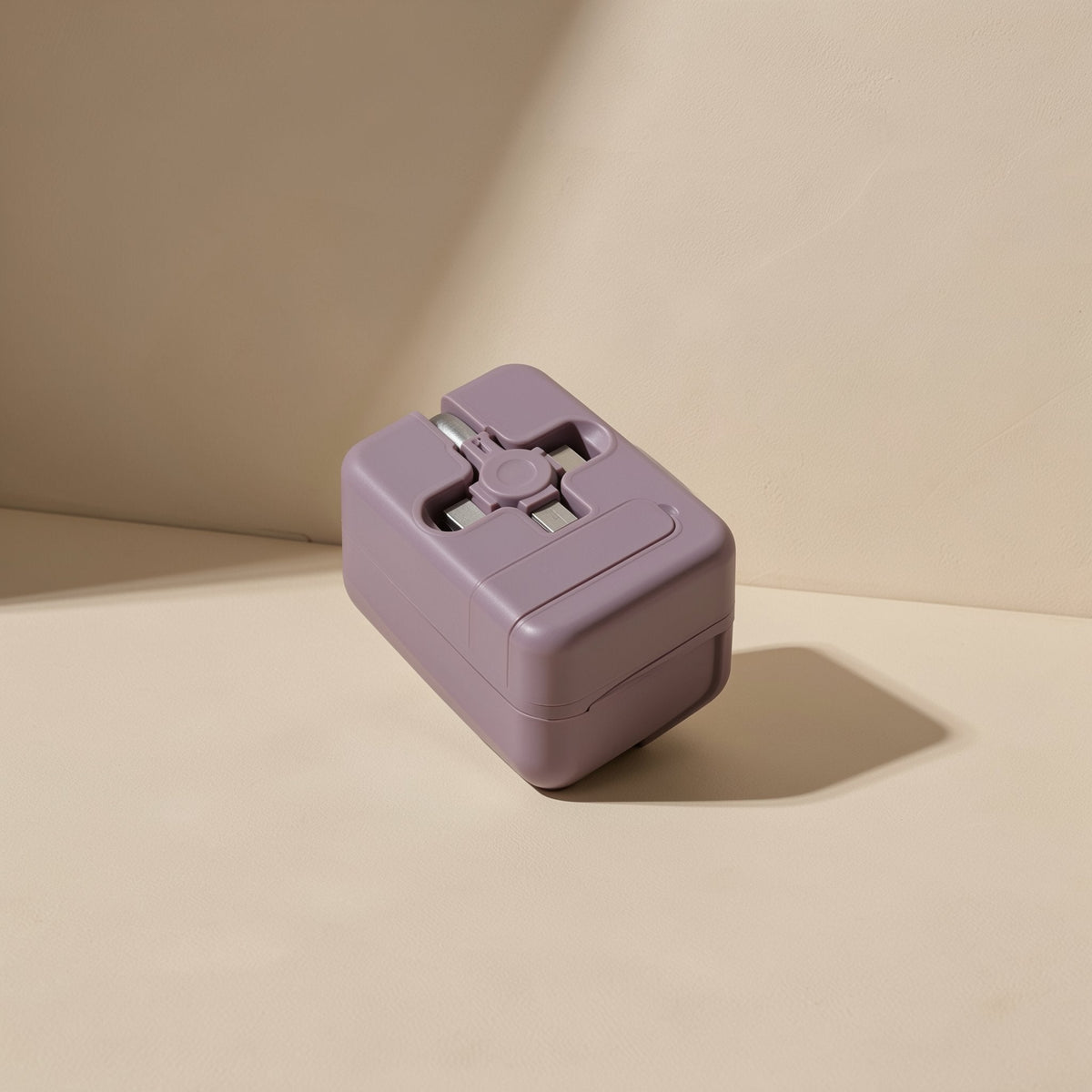 Trioflow Three-In-One TPE Data Cable in dusty purple, compact square case resting on a beige surface