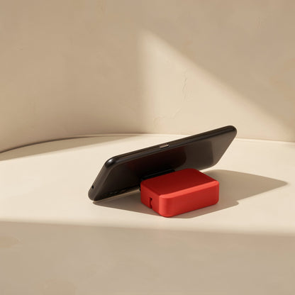 Trioflow Three-In-One TPE Data Cable – red cable case propped under a black smartphone, working as a small phone stand