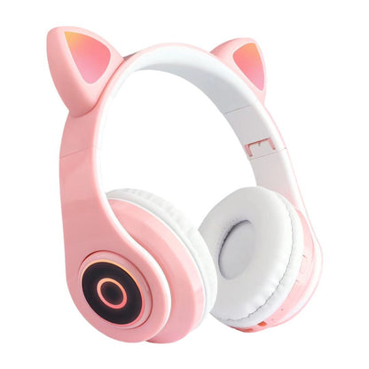 Purrtone – Pink and white cat ear headset with orange glowing ear panels and ring light on the earcup, three-quarter view