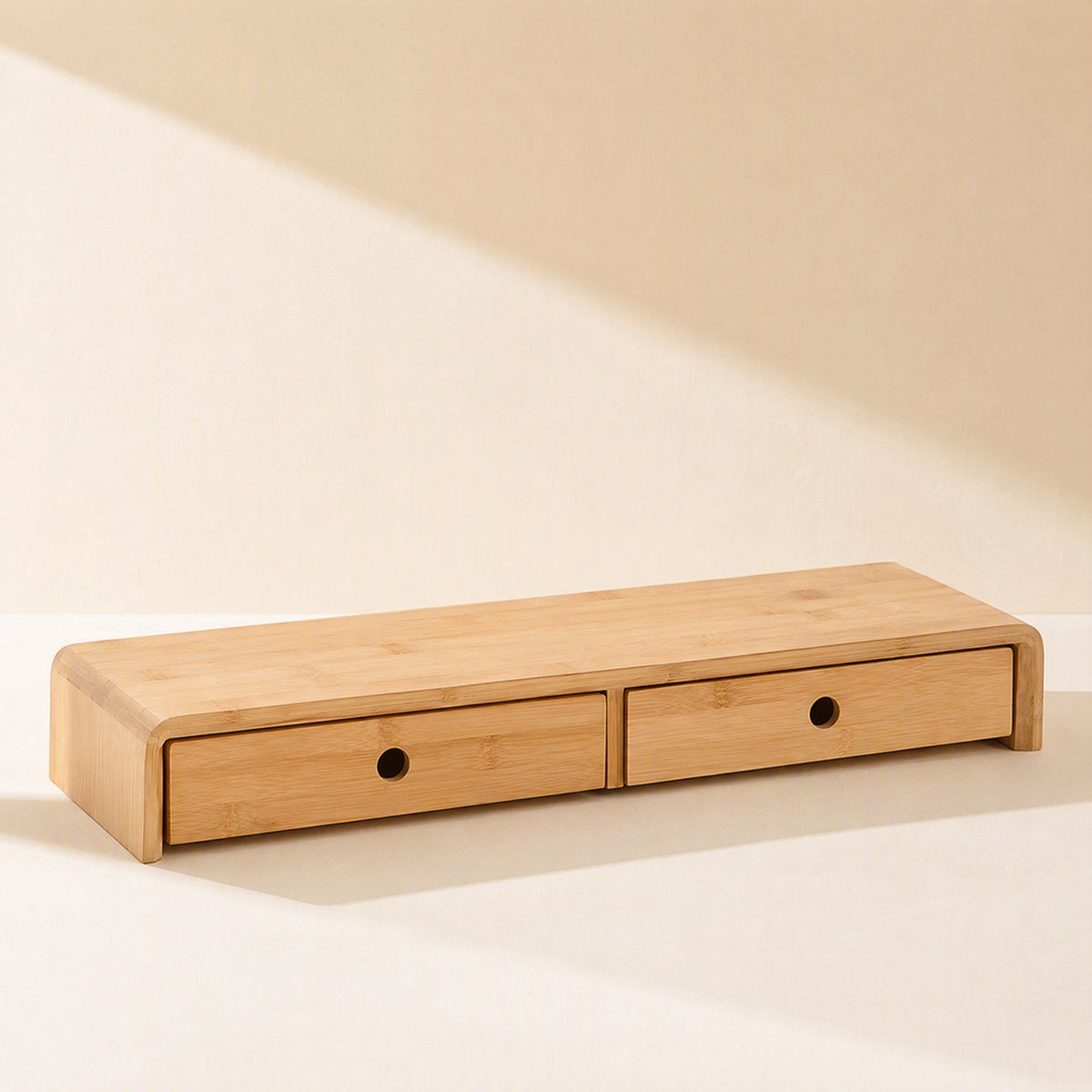 Bamboorise Bamboo Computer Monitor Stand with two small drawers with round finger holes, angled view