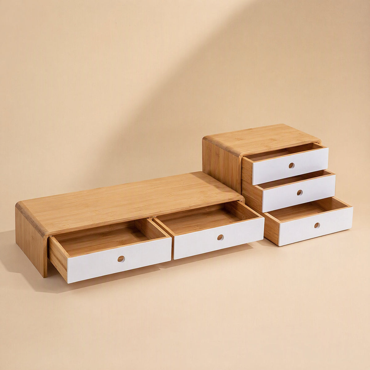 Bamboorise – Bamboo monitor stand with two open white drawers beside a three-drawer bamboo and white desktop organizer