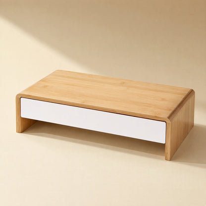 Bamboorise – Bamboo monitor stand with a single white front drawer, seen from a high three-quarter angle