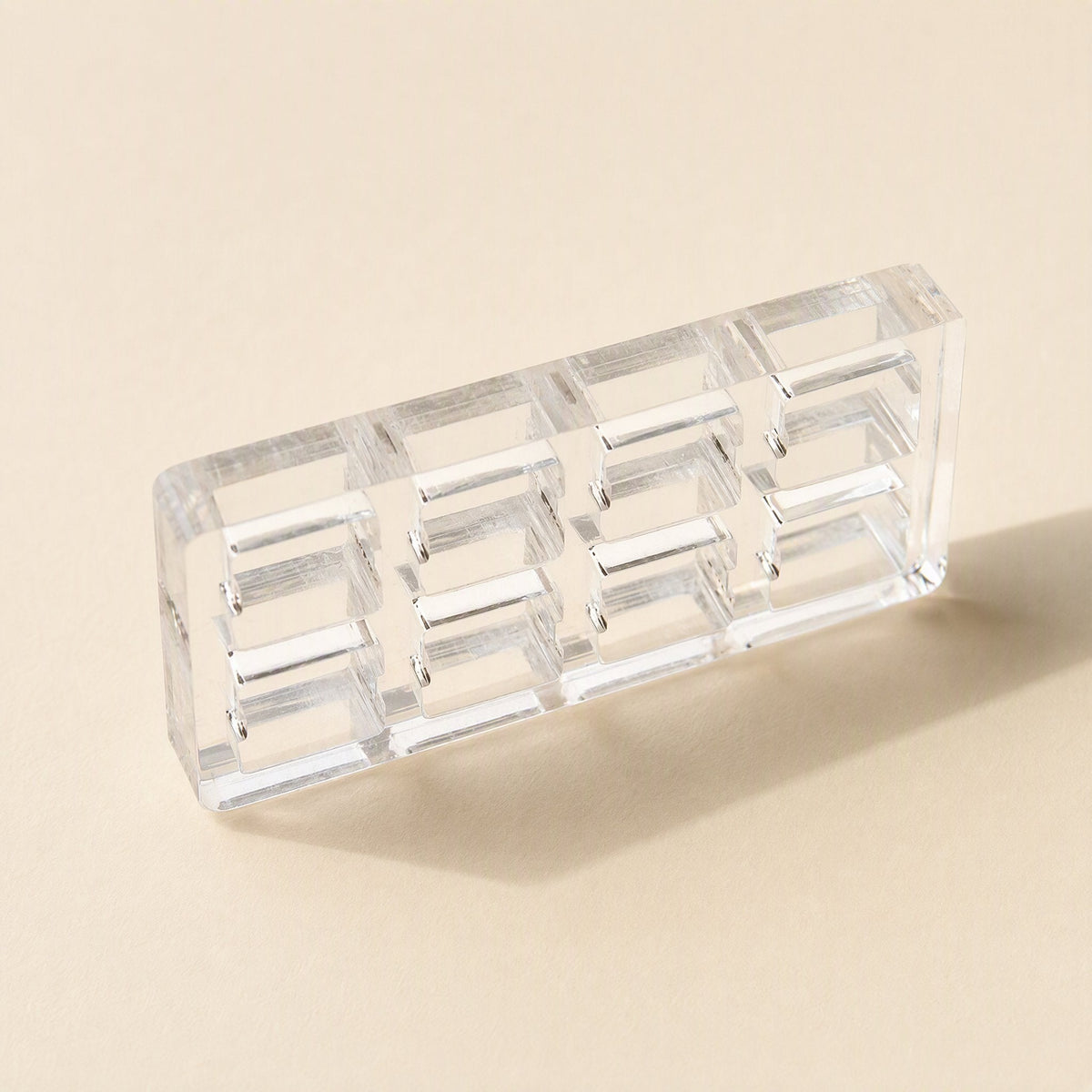 Switchframe – Small 4x2 clear acrylic switch tester frame with eight openings, angled on a beige background