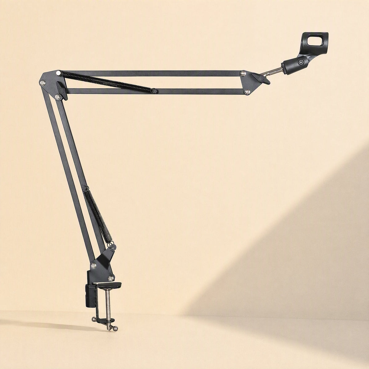 Deskarm Desktop Microphone Stand Bracket extended horizontally with desk clamp on a cream backdrop