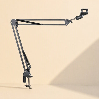 Deskarm Desktop Microphone Stand Bracket extended horizontally with desk clamp on a cream backdrop