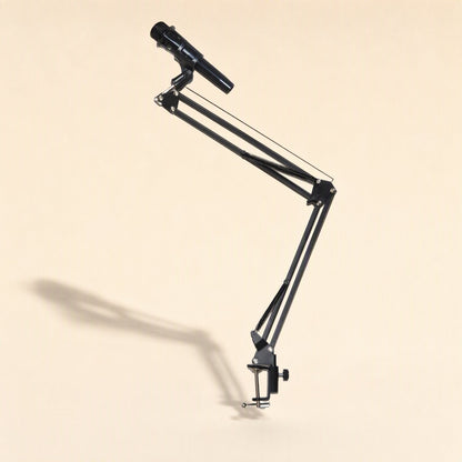 Deskarm – Black metal cantilever arm with microphone attached, angled upward with a long shadow behind