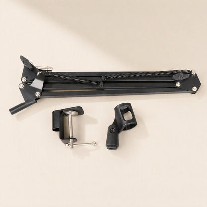 Deskarm – Disassembled arm folded flat beside the separate desk clamp and microphone holder