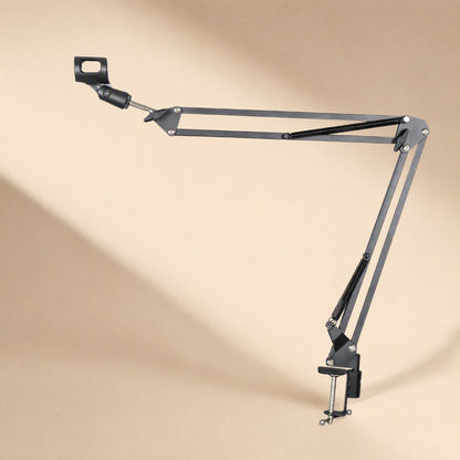 Deskarm – Metal cantilever mic arm with clamp, shown from the right on a warm beige background with soft shadow