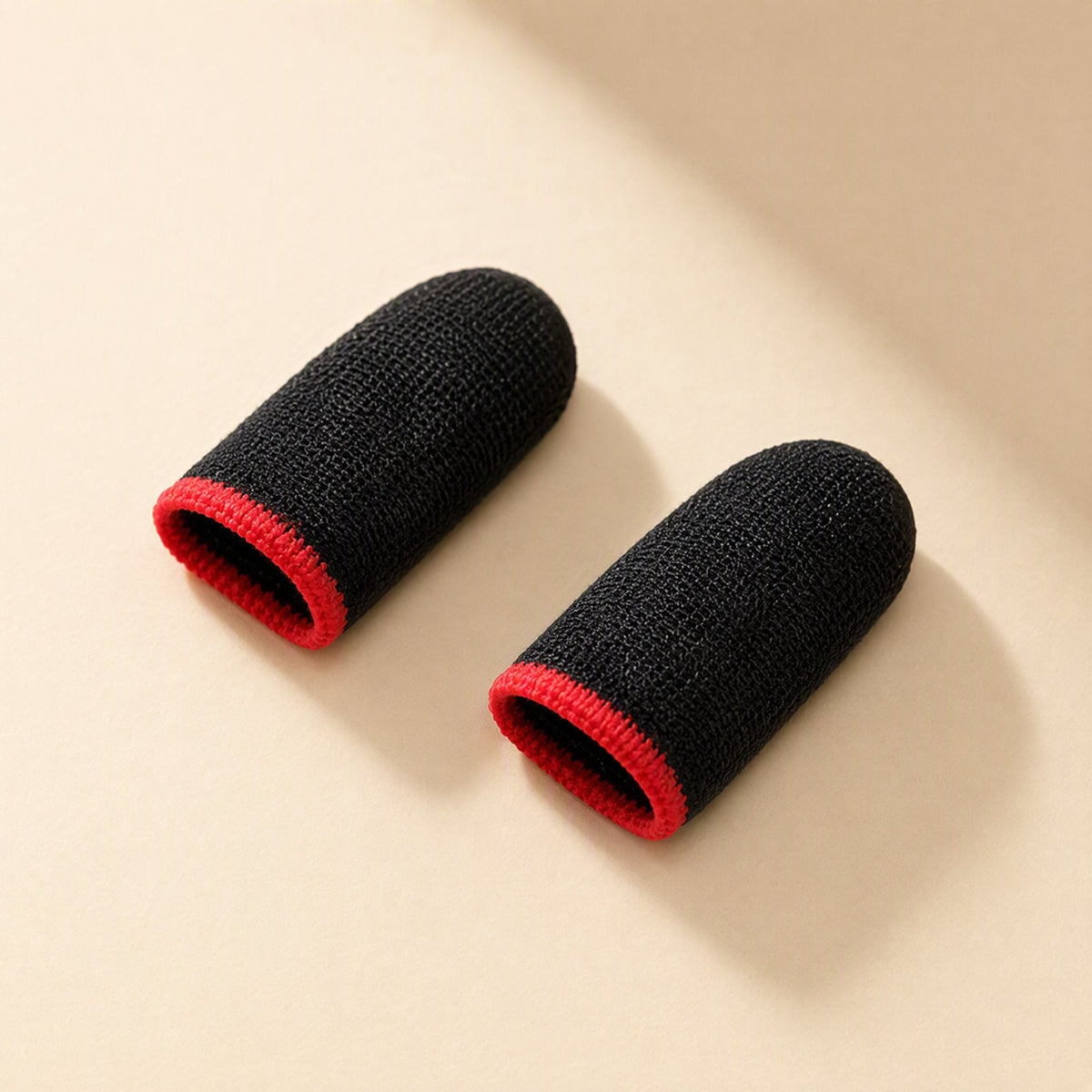 Silvertouch – Pair of black knitted finger sleeves with red ribbed openings, viewed from the open end
