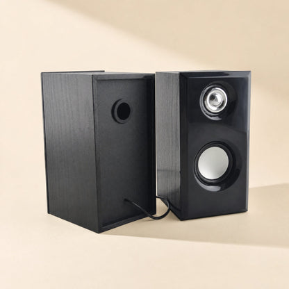 Woodtone – Back and front of the black-finish speakers, showing the rear port hole and attached cable