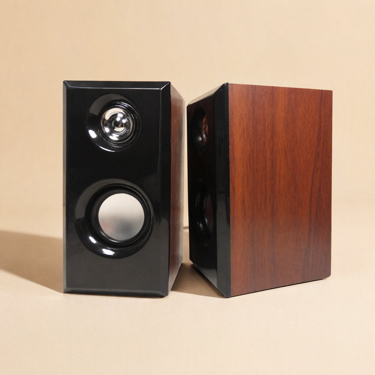 Woodtone – Two walnut-finish speakers side by side, one facing front and one turned to show the wood-grain side panel