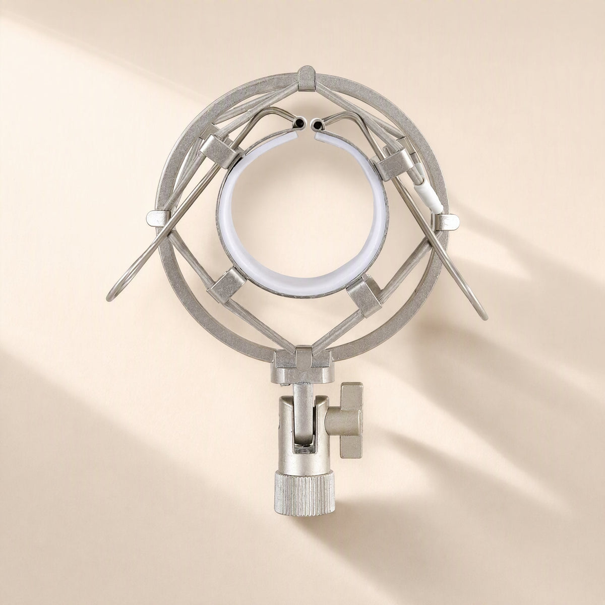 Micbuffer Condenser Microphone Shock Mount in silver, front view of the round frame and white-lined ring