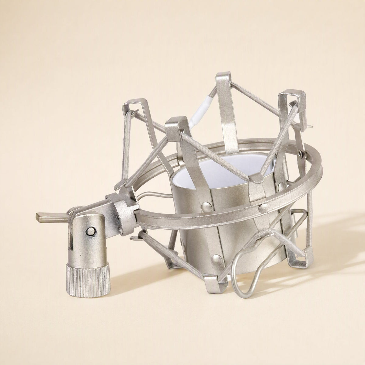 Micbuffer – Silver suspension mount lying on its side, showing the metal frame, cords and threaded adapter