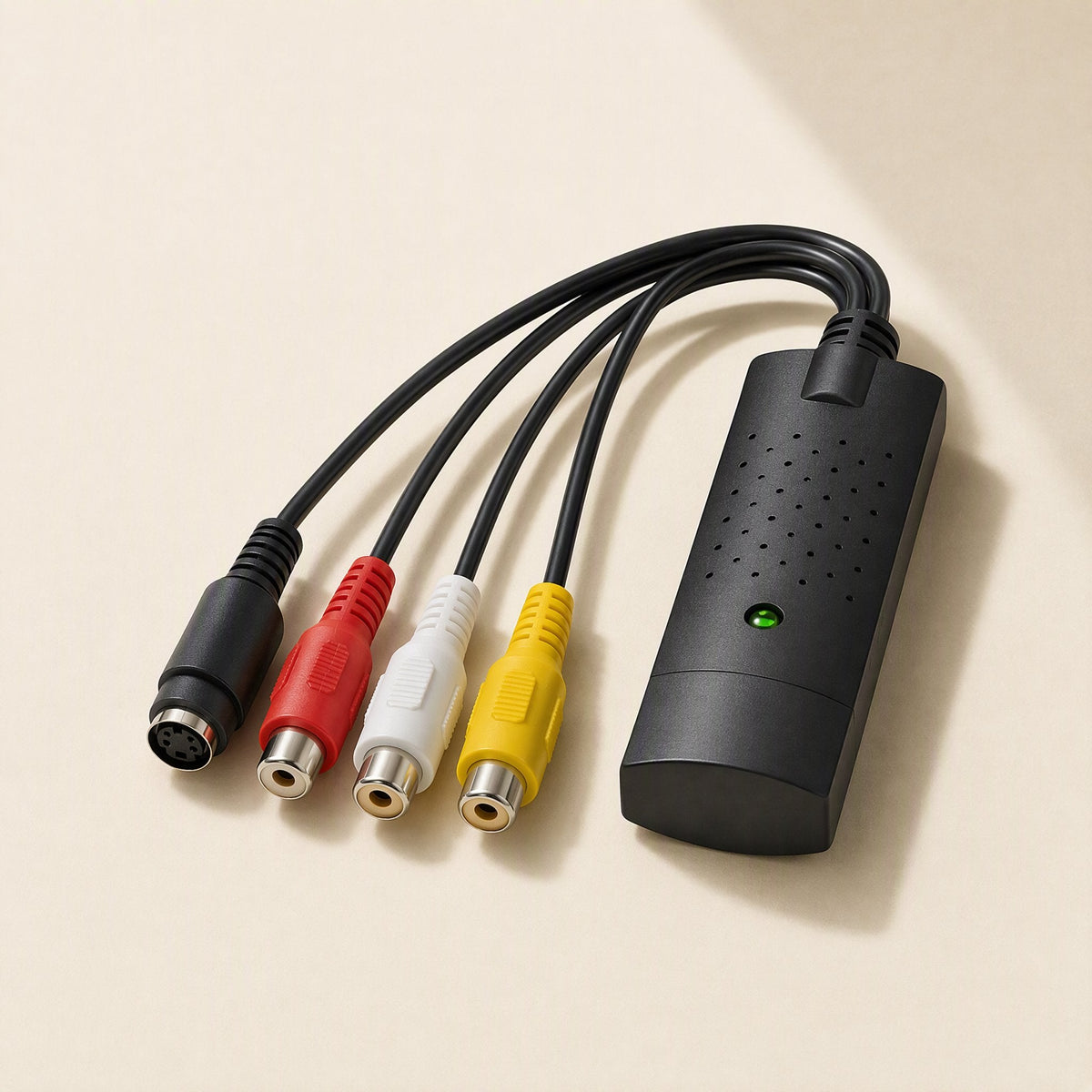 Videolink – Top view of the black capture card with its green indicator light and yellow, white, red and S-Video leads