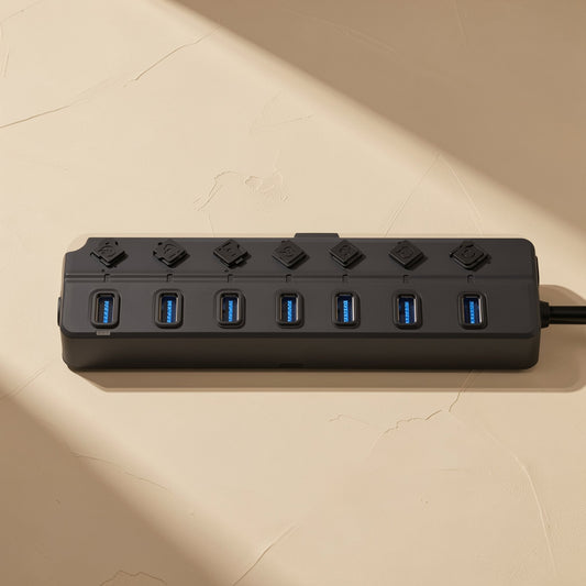 Switchhub – Top-down view of seven blue USB 3.0 ports with a small switch above each on the black hub
