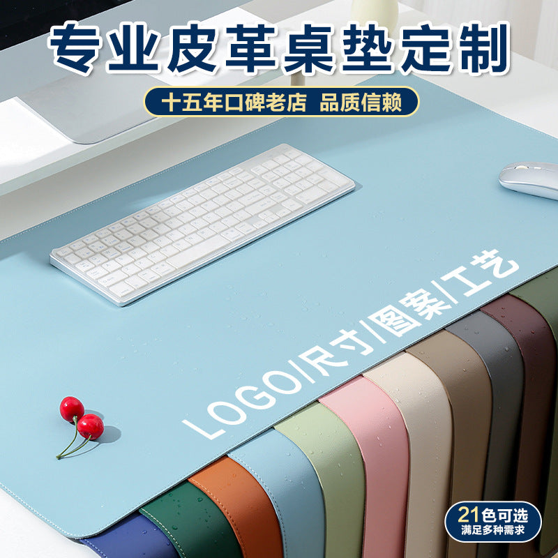 Hideweave – Light blue leather desk mat under a white keyboard and mouse, with a row of colour swatches along the bottom edge