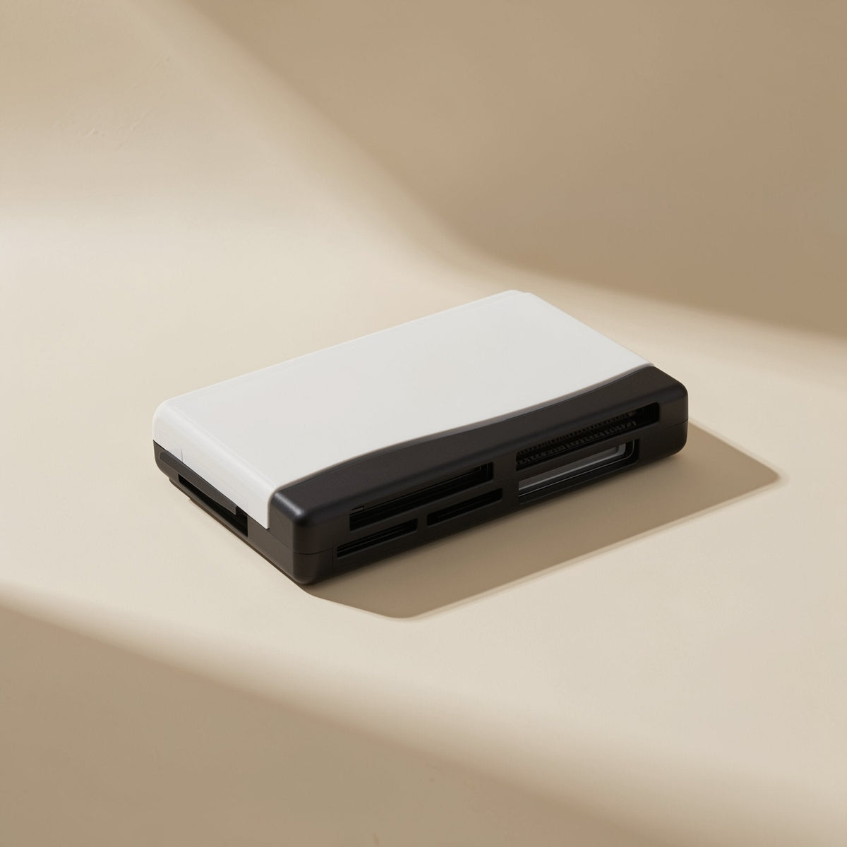 Chipplug – Two-tone white and black card reader seen from a low angle, showing slots along the front edge