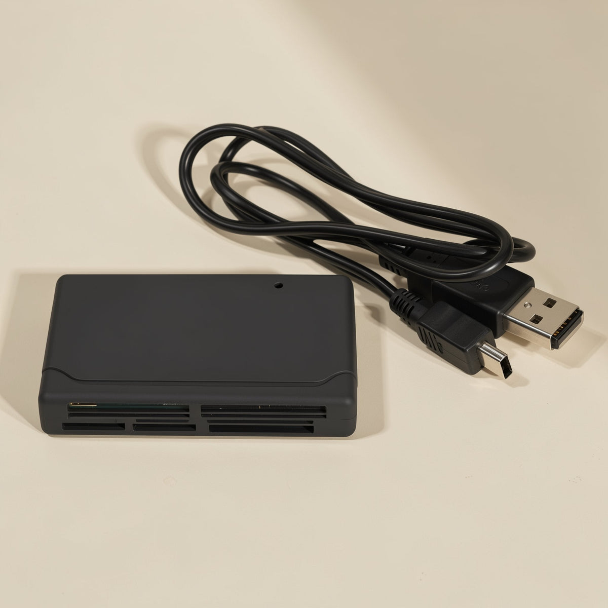 Chipplug – Top-down view of black card reader with coiled cable ending in USB-A and mini-USB connectors