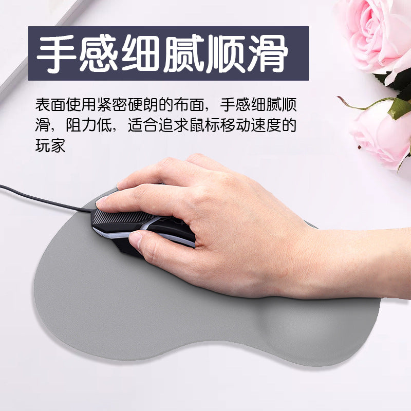 Wristlune – Hand resting on a gray wrist mouse pad while holding a black gaming mouse, with pink roses behind