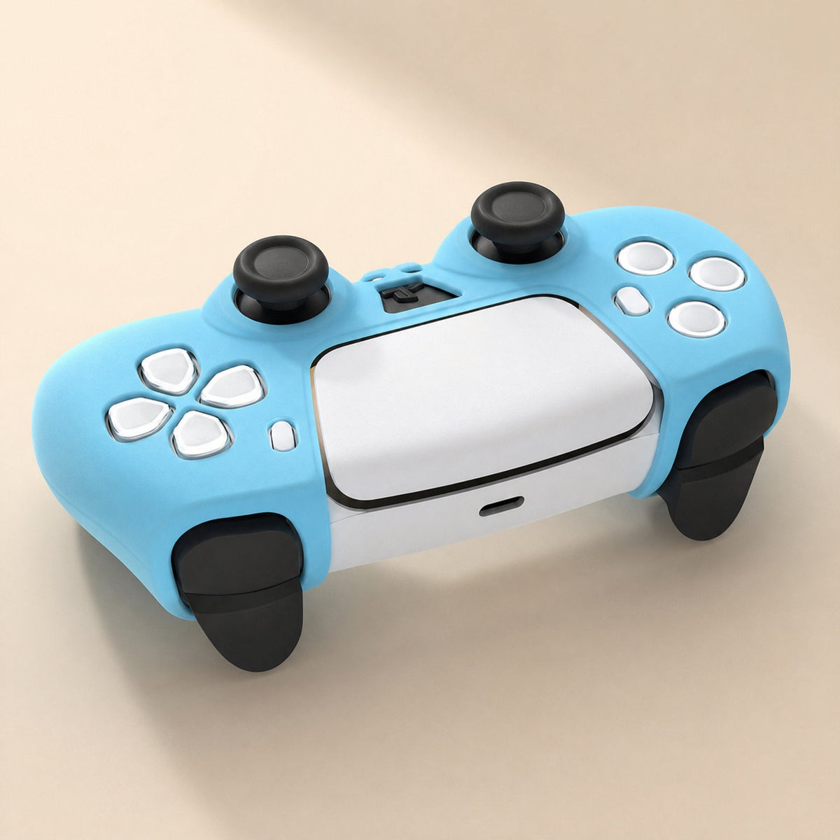 Padshield – Top-down angled view of a light blue silicone cover on a white PS5 controller with button cutouts