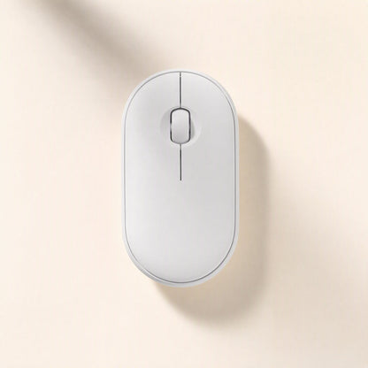 Quietcursor – White wireless mouse viewed from above, with a scroll wheel and centre seam, on a soft cream backdrop