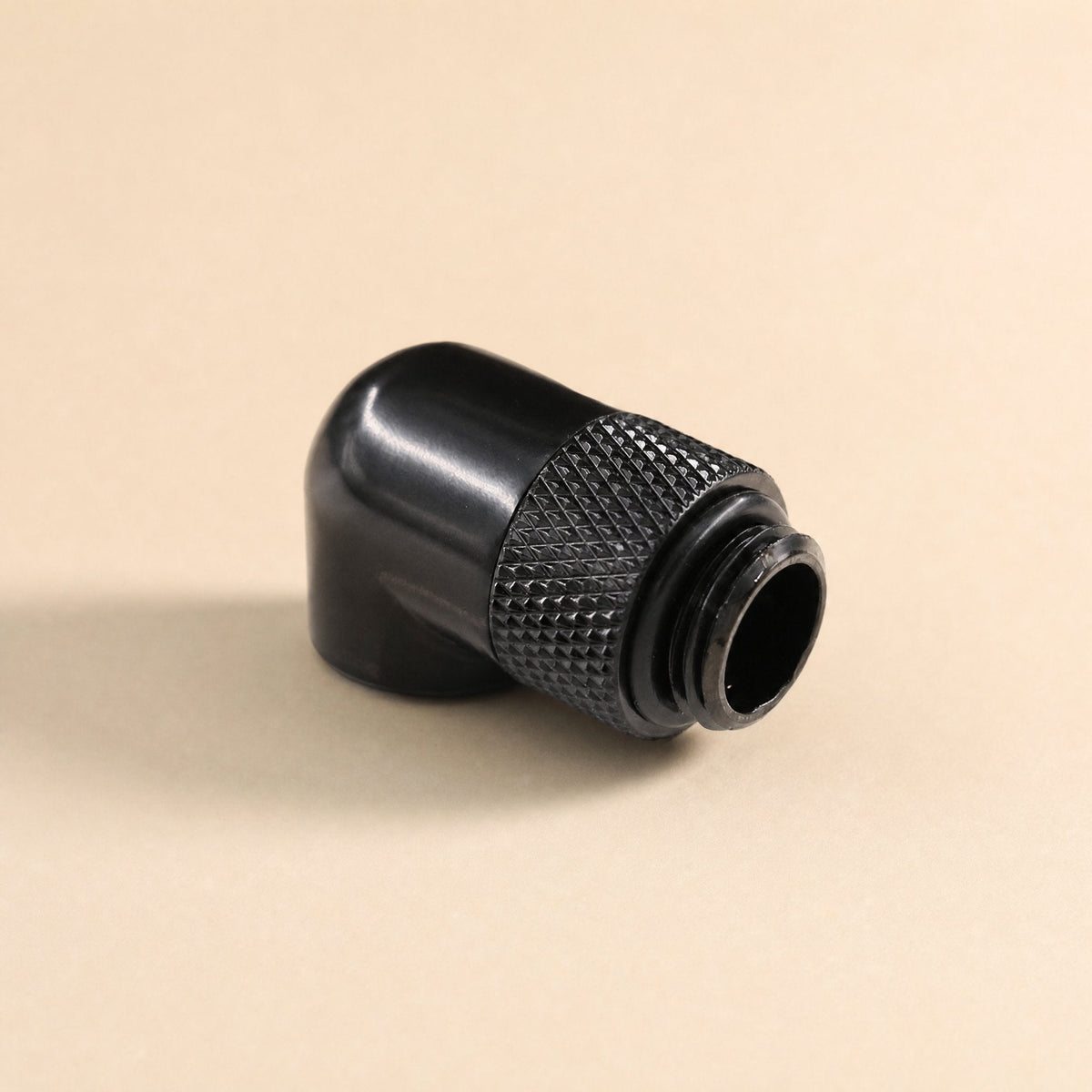 Swivelbend – Black 90-degree rotating fitting from the rear, showing the smooth curved body and knurled swivel ring