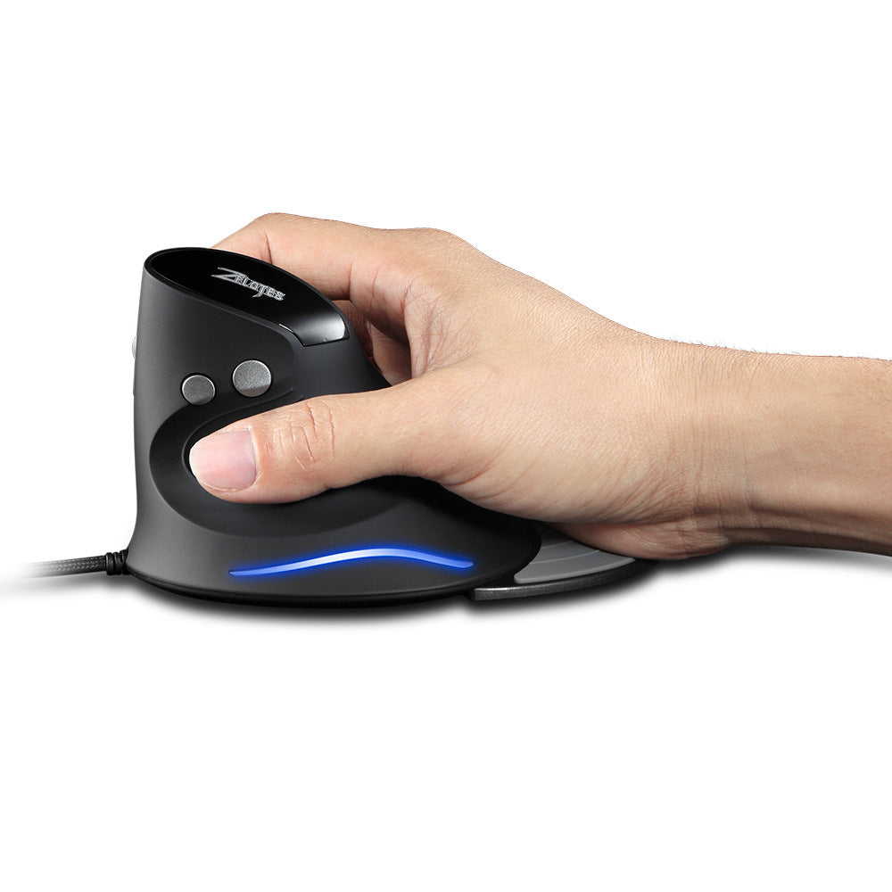 Turnmouse – Hand gripping the black vertical mouse in a handshake position, thumb resting on the side, blue light on