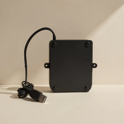 Trackroll – Back of the black trackball mouse with four rubber feet, mounting tabs and a USB plug on the cord