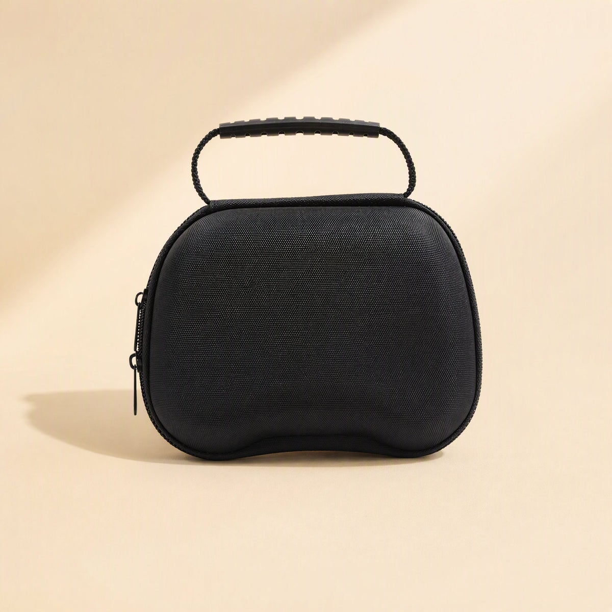 Padcove PS5 Controller Storage Bag – black controller case with ribbed top handle and zip closure on a warm beige background