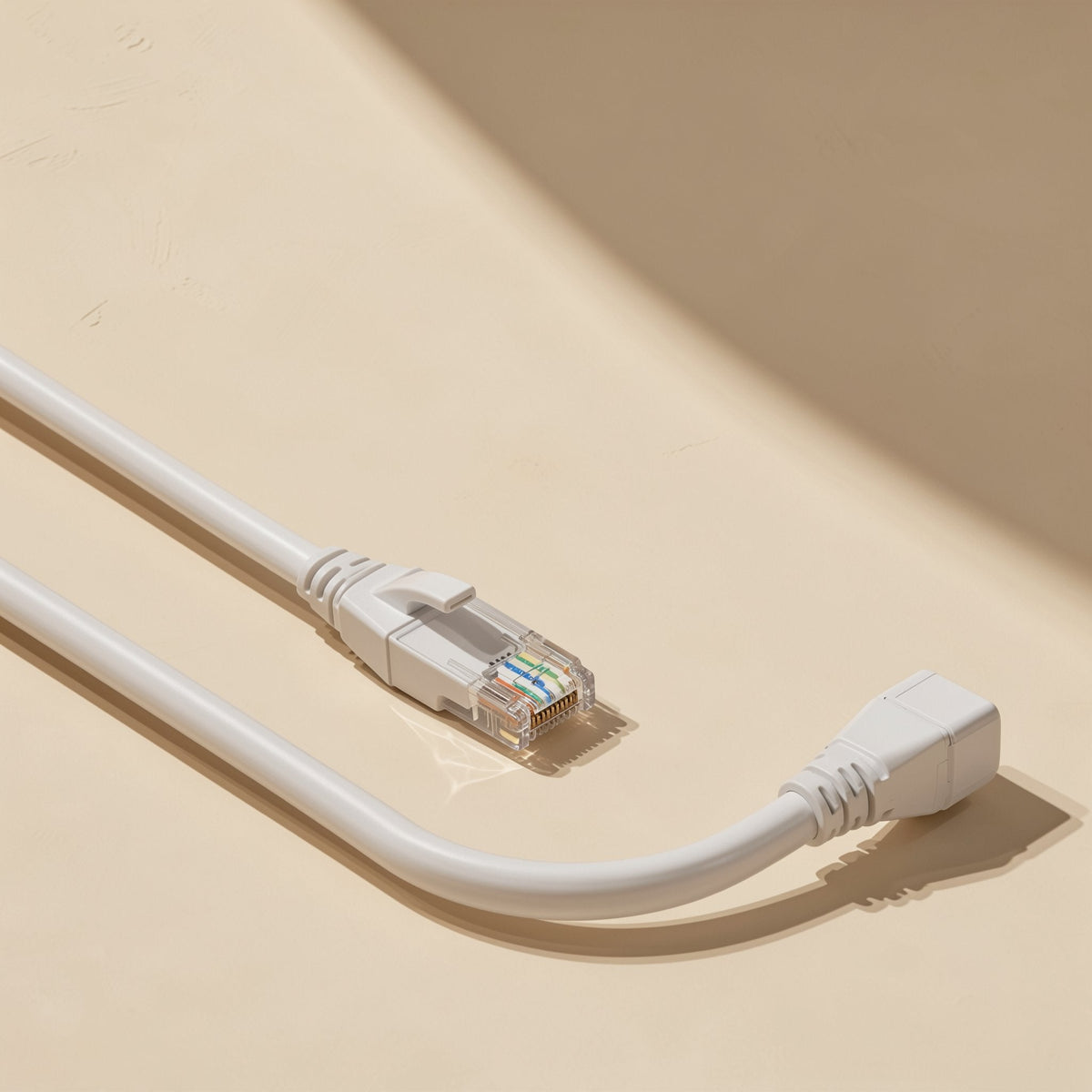 Pairpath – Long white Ethernet cable curved on a beige surface, one RJ-45 plug at the front and a right-angle end