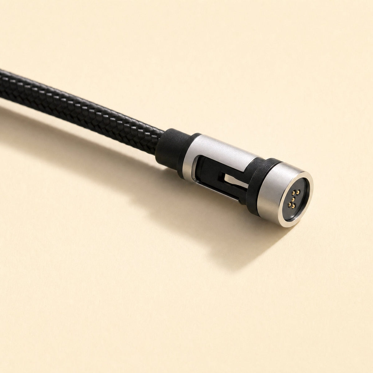 Snapcharge – Close-up of the magnetic cable end showing gold contact pins and a metal housing slot