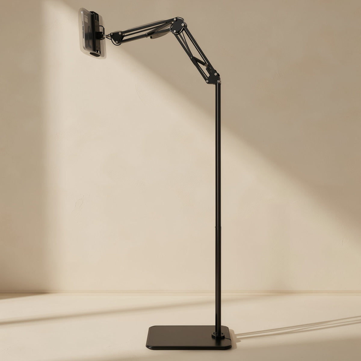 Risepost – Slim black floor stand with the arm angled upward and a phone clamped at the top, shown from the side