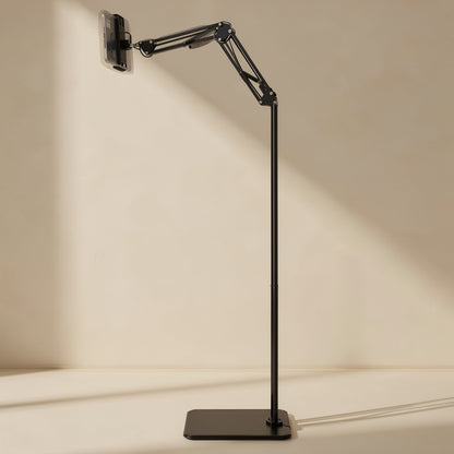Risepost – Slim black floor stand with the arm angled upward and a phone clamped at the top, shown from the side